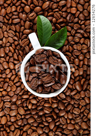 Cup with coffee on a background coffee grains. 12654276