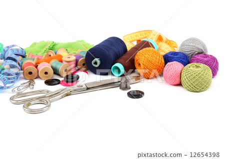 Colored threads, buttons, fabric and scissors. Colored threads, buttons, fabric and scissors. 12654398