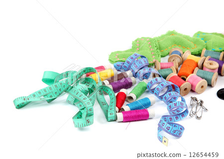 Colored threads, buttons and fabric. 12654459