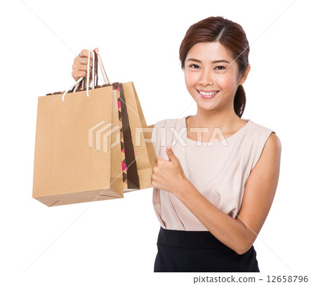 Woman with paper bag and thumb up 12658796