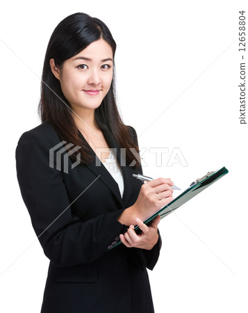 Asian businesswoman take note on clipboard 12658804
