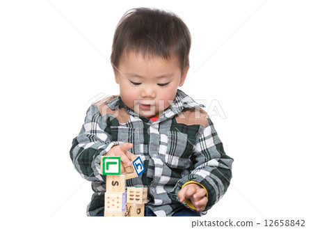 Asian baby boy play with toy block 12658842