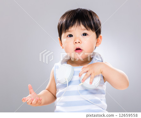 Baby with headphone on shoulder 12659558