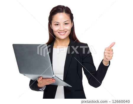 Businesswoman with laptop and thumb up 12660040