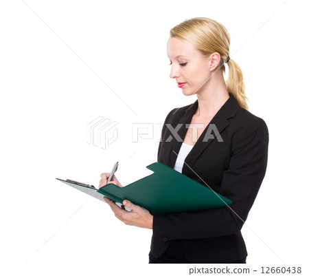 Caucasian businesswoman write on clipboard 12660438