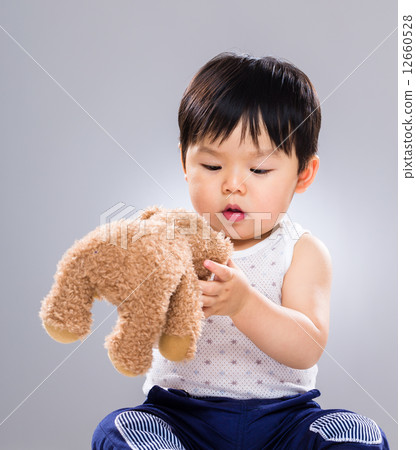 Little boy playing with doll bear Little boy playing with doll bear 12660528