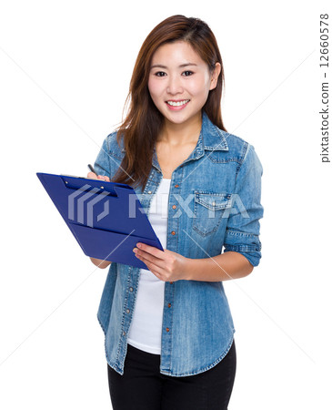 Asian young woman write on clipboard Asian young woman write on clipboard 12660578