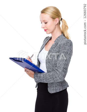 Business executive write on clipboard Business executive write on clipboard 12660792