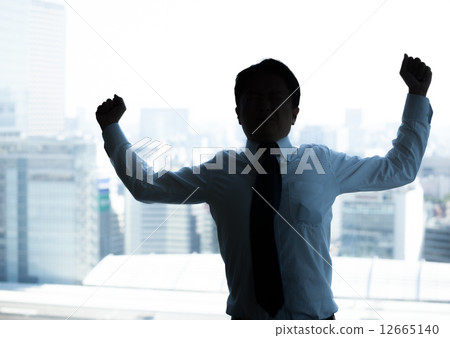 A businessman growing at the office A businessman growing at the office 12665140