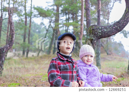 children two brother sister together forest outdoor 12669251