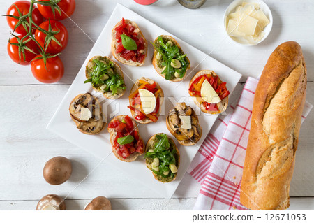 Bruschetta with beans and arugula, mushrooms, goat cheese 12671053