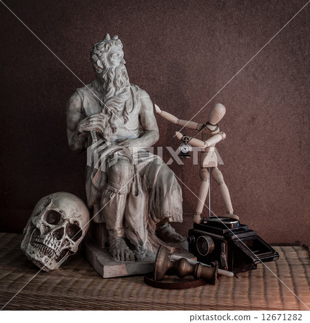 Still life of moses statue ,skull,wooden figure on mat Still life of moses statue ,skull,wooden figure on mat 12671282