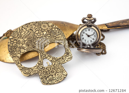 Small watch with chain ,brass ladle,skull necklace on white 12671284
