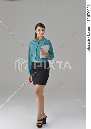 an confident asian office lady smiling with a tablet an confident asian office lady smiling with a tablet 12676056