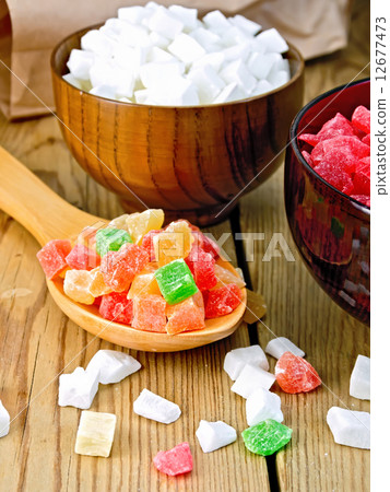 Candied fruit colored in spoon on board Candied fruit colored in spoon on board 12677473