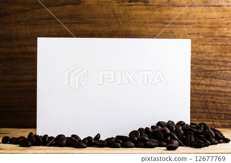 Paper with coffee bean on wood background. Paper with coffee bean on wood background. 12677769