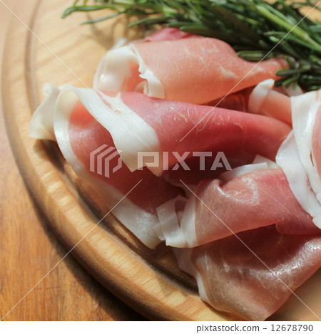 slices of ham on a cutting board slices of ham on a cutting board 12678790