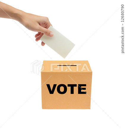 图库照片: hand putting a voting bollot into the box isolated on