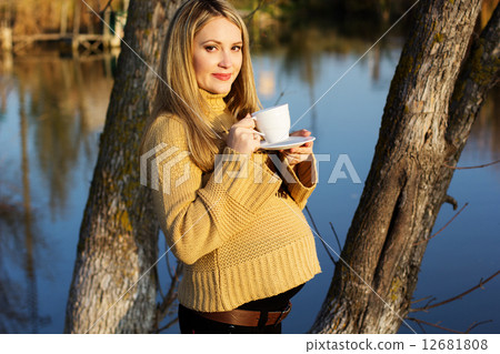 Pregnant woman on the autumn lake 12681808