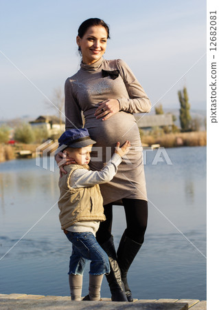 Little boy with her mother on the autumn lake 12682081