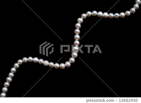 White pearls on the black silk as background 12682930