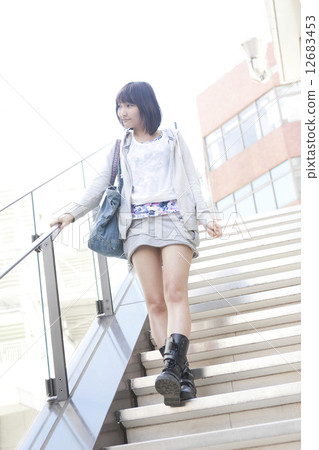 A woman descending the stairs A woman descending the stairs 12683453