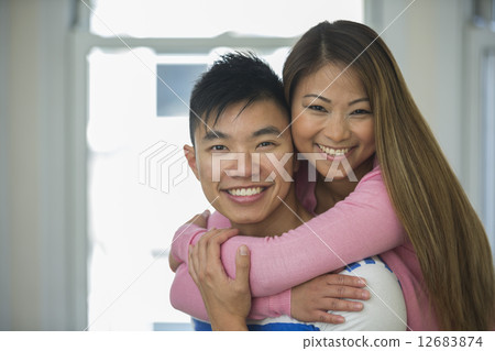 Happy Asian Couple together at home. 12683874