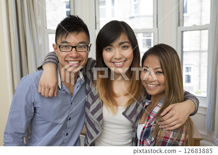 Portrait of three Asian friends relaxing at home. 12683885