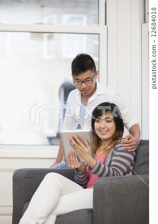 Portrait of happy Asian Couple relaxing at home. Portrait of happy Asian Couple relaxing at home. 12684018
