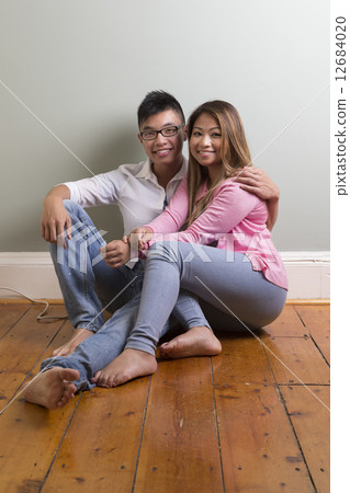 Portrait of happy Asian Couple relaxing at home. Portrait of happy Asian Couple relaxing at home. 12684020