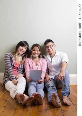 Group of young Asian friends looking at a digital Tablet. Group of young Asian friends looking at a digital Tablet. 12684022