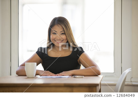 Asian business woman sitting in her office. 12684049