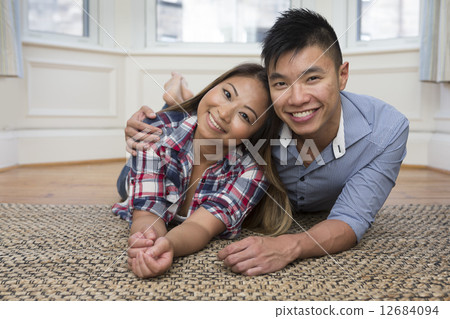Happy Chinese couple at home together Happy Chinese couple at home together 12684094