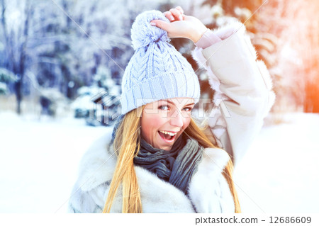 Young beautiful girl posing in winter park on a sunny day Young beautiful girl posing in winter park on a sunny day 12686609