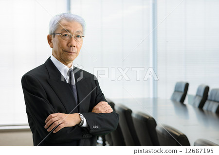 Senior CEO standing in the executive meeting room 12687195