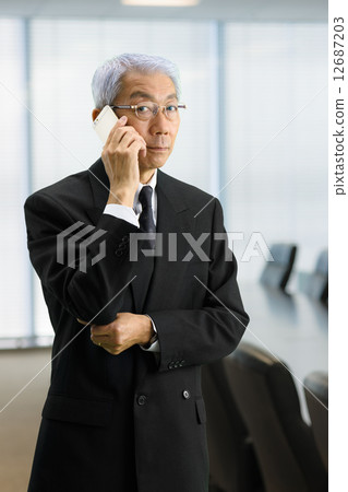Senior CEO standing in the executive meeting room 12687203