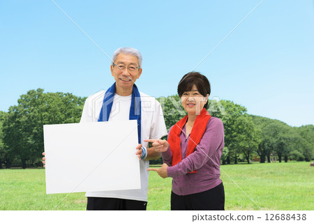 Senior couple having a whiteboard at a blue sky park 12688438