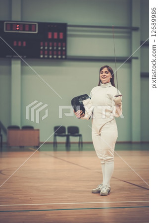 Young woman fencer with epee 12689986