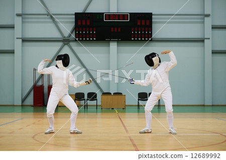 Two women fencers on a training 12689992