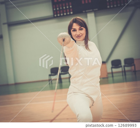Young woman fencer with epee 12689993