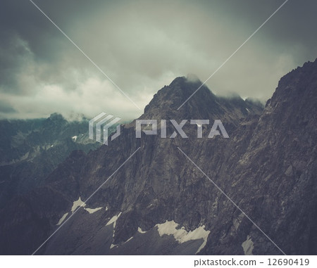 Fog over high mountain peak Fog over high mountain peak 12690419