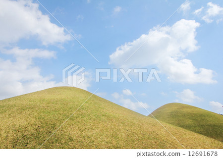 Hill landscape with blue skies 12691678