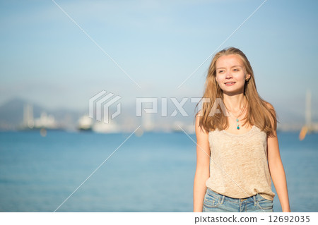 Beautiful young girl on the beach in Cannes 12692035