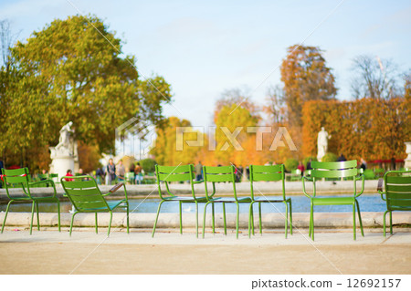 Traditional green chairs in Tuileries garden 12692157
