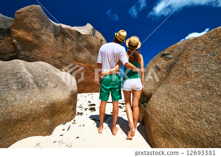 Couple in green on a beach at Seychelles Couple in green on a beach at Seychelles 12693381