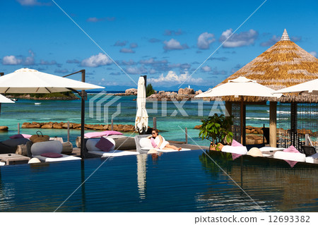 Woman at poolside Woman at poolside 12693382