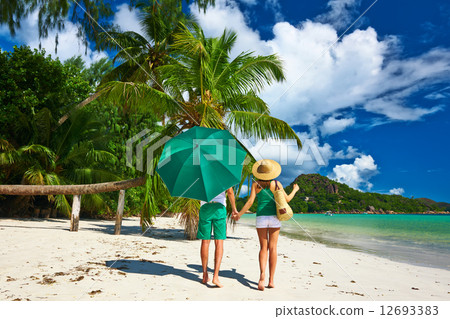 Couple in green on a beach at Seychelles Couple in green on a beach at Seychelles 12693383