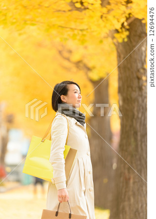 A woman walking in ginkgo trees 12694476