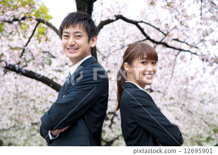 在櫻花前的西裝男女 12695901
