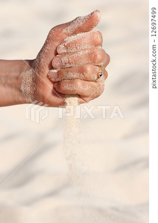 Sand running through hands Sand running through hands 12697499
